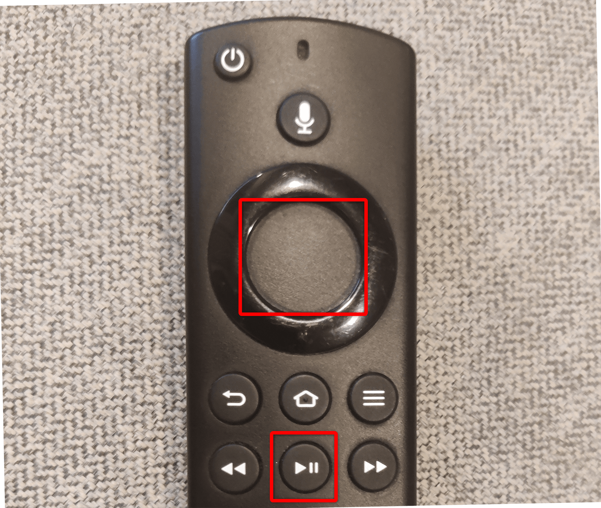 Select and Play/Pause buttons highlighted on an Amazon Fire TV Stick remote.