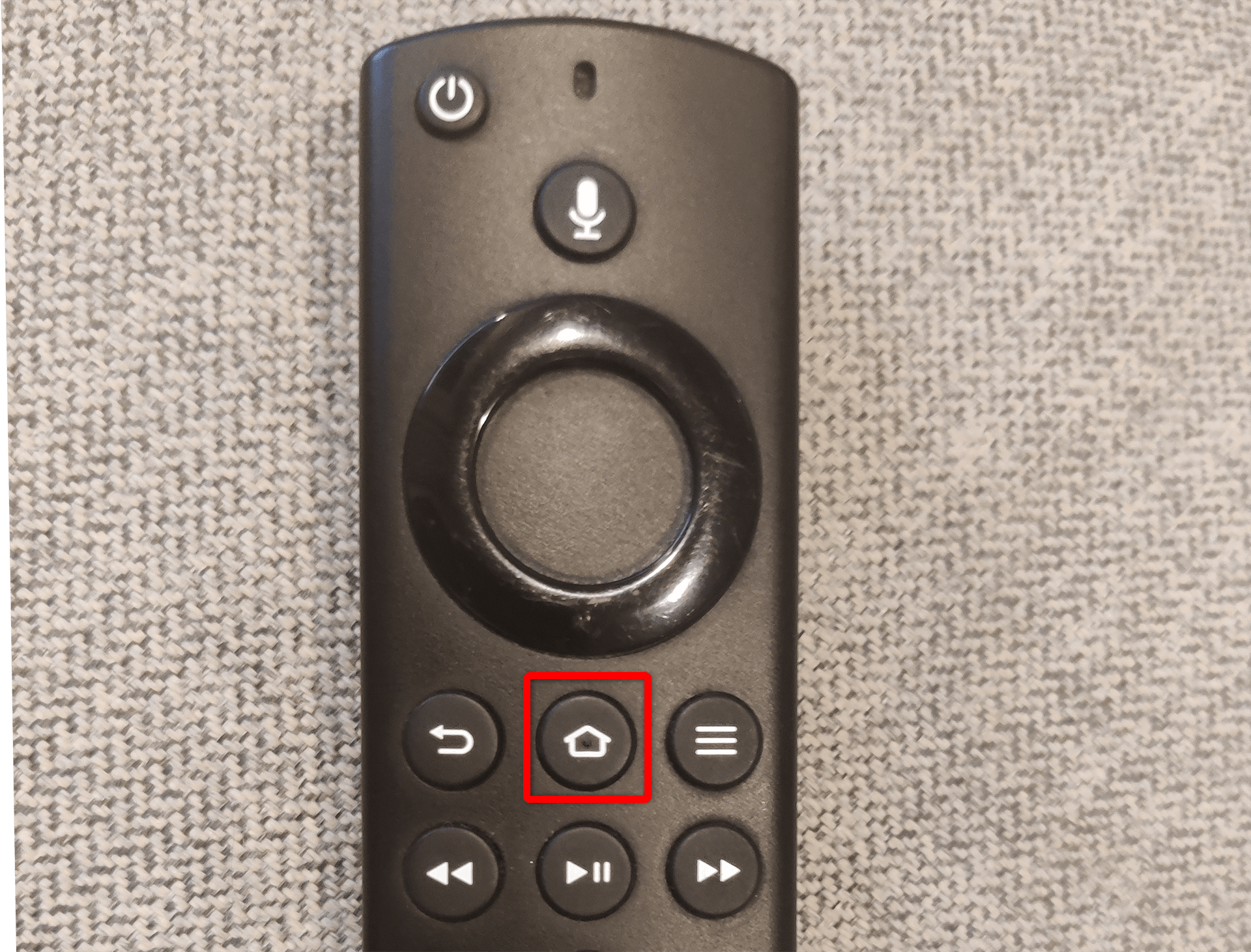 Home button highlighted on a Fire TV Stick remote.
