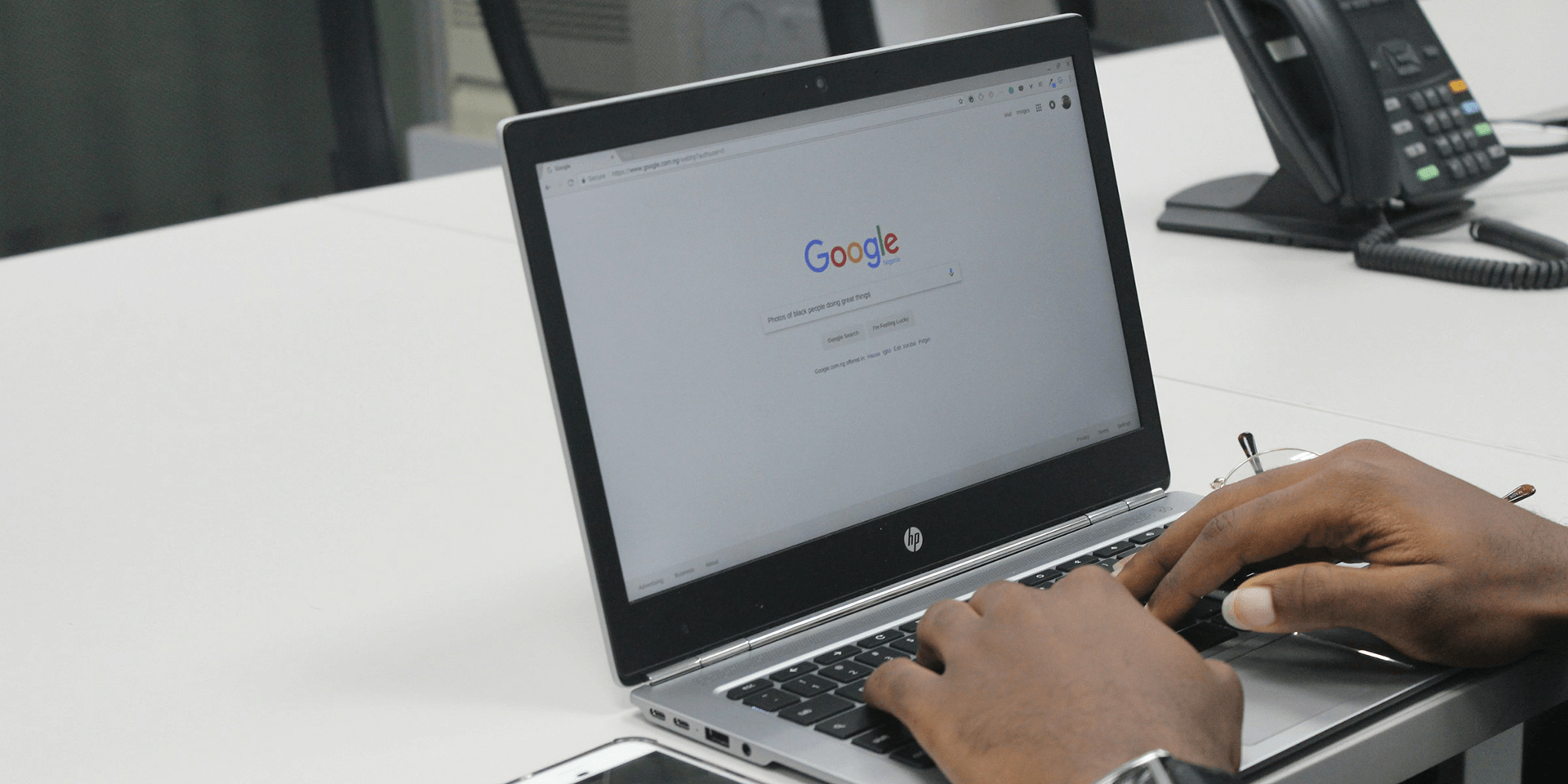 A person using Google on an HP laptop.
